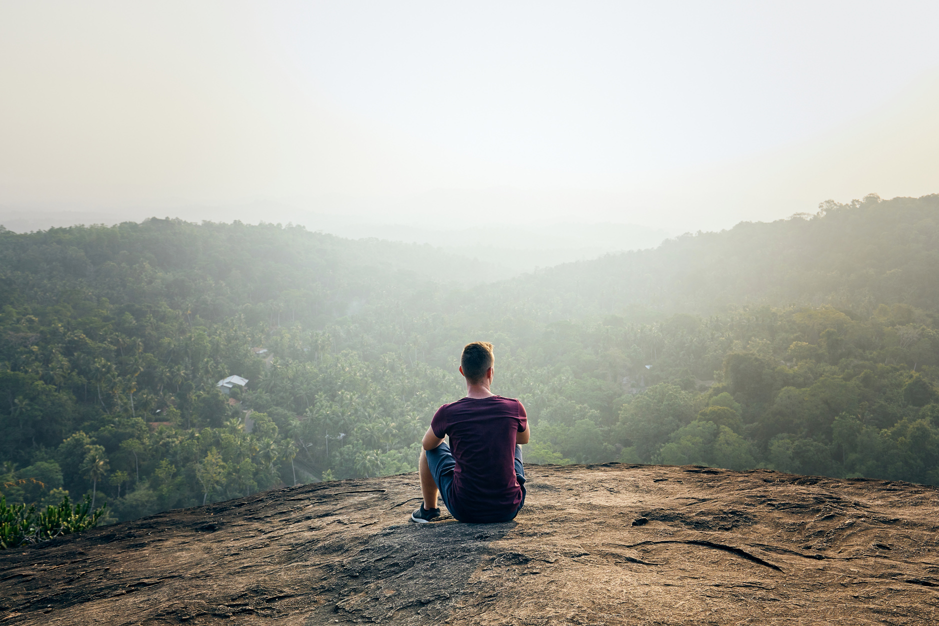 Man Resting on Top of Rock